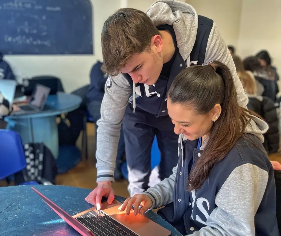 Due studenti IEXS collaborano a un lavoro al computer
